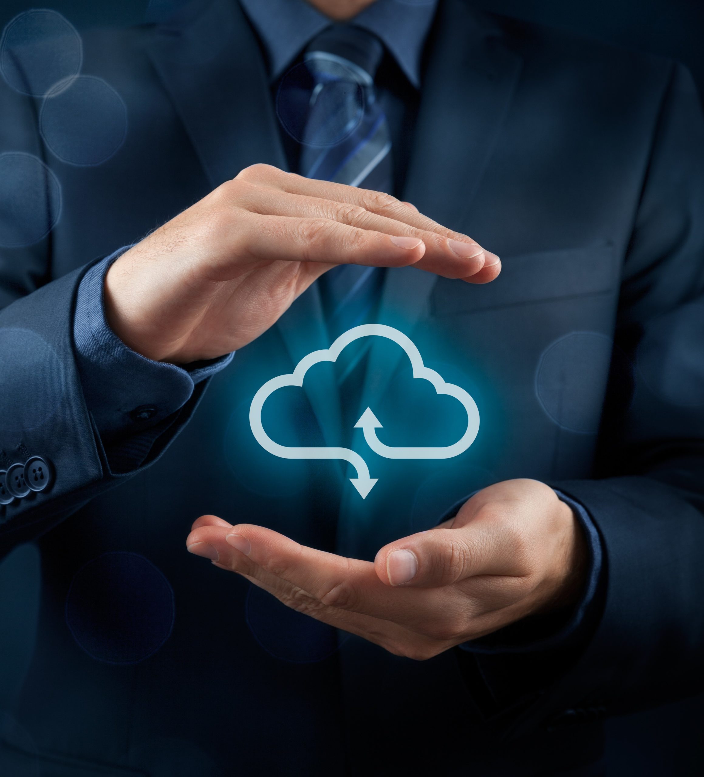 Businessman in suit holding cloud icon